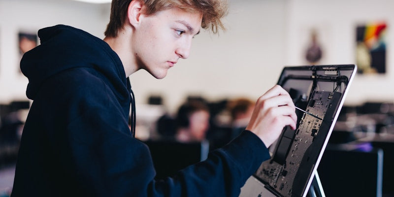 a young man working on a laptop computer