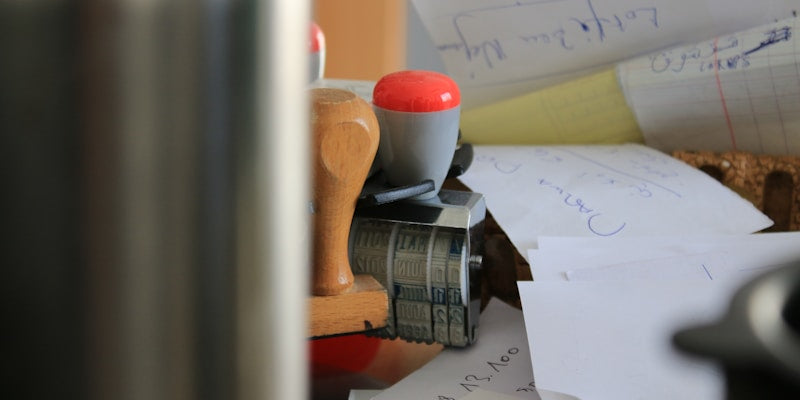 gray and red stamper on white paper