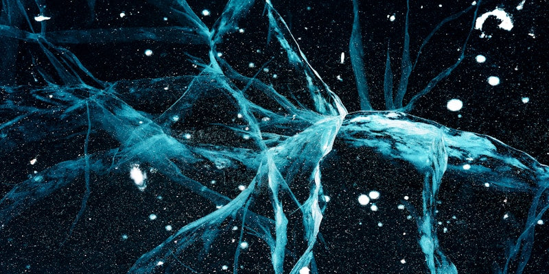 a bunch of blue ice on a black background